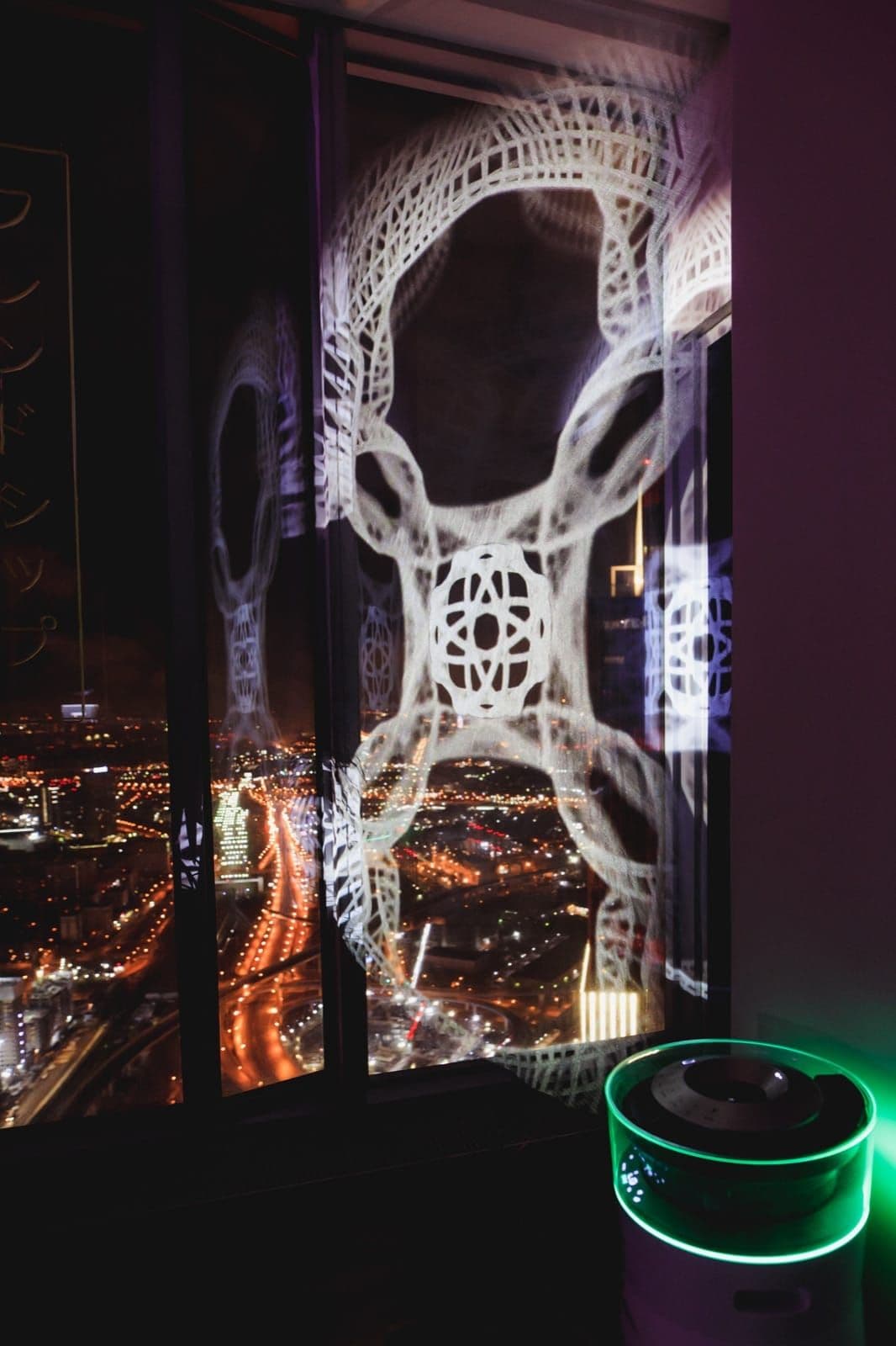 A luminous white pattern appears over the city view on a panoramic window.