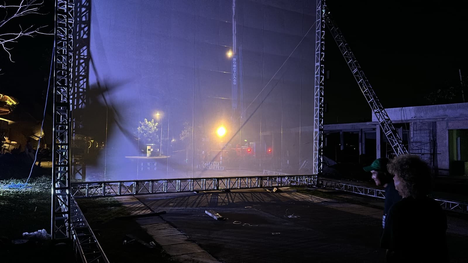 Night — the screen lit foggy purple, post-storm calm, partial assembly visible at frame edges.