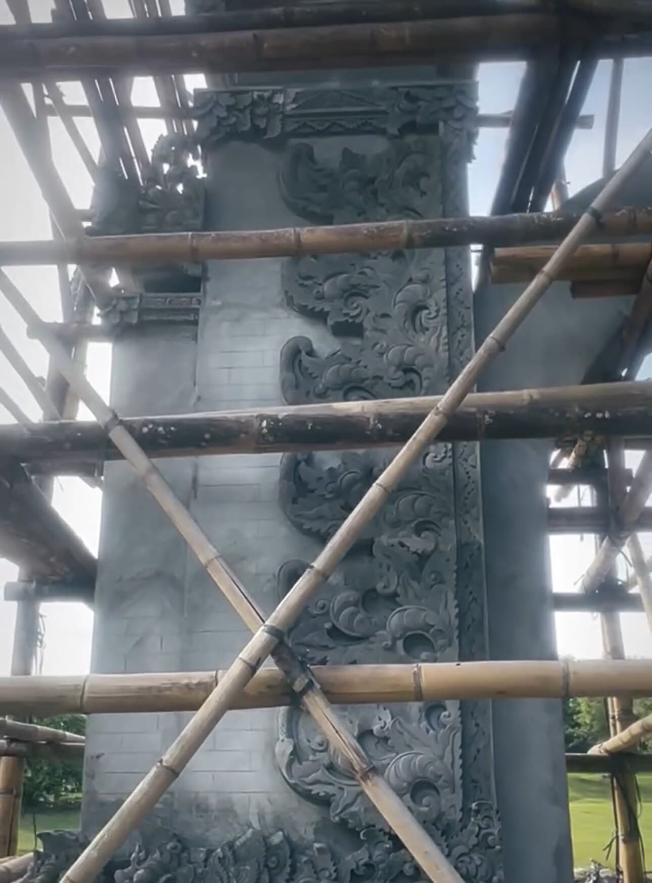 Carved architectural details being installed on a Nuanu Gate tower during construction
