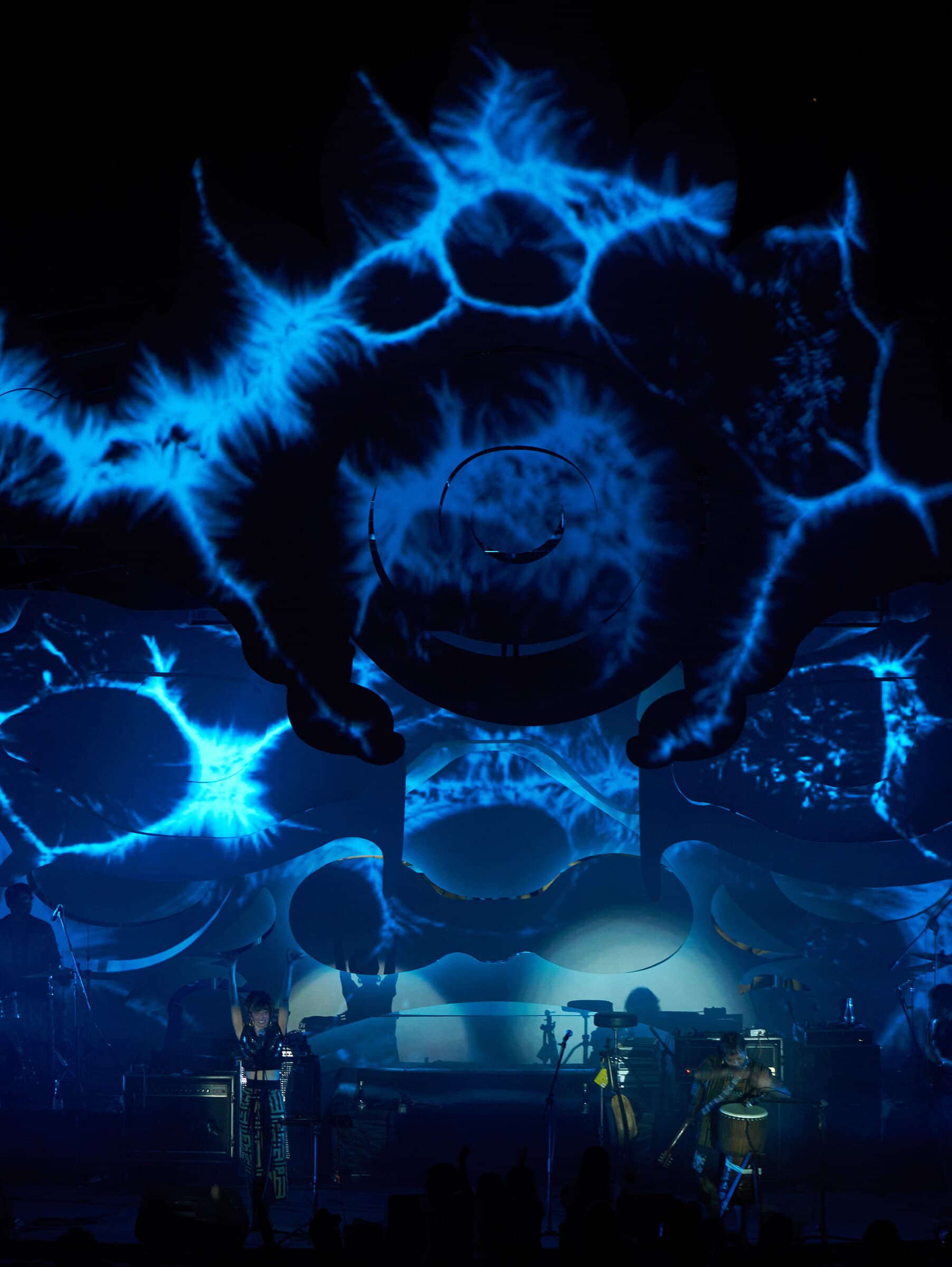A vertical close view of blue organic projections across the central stage sculpture