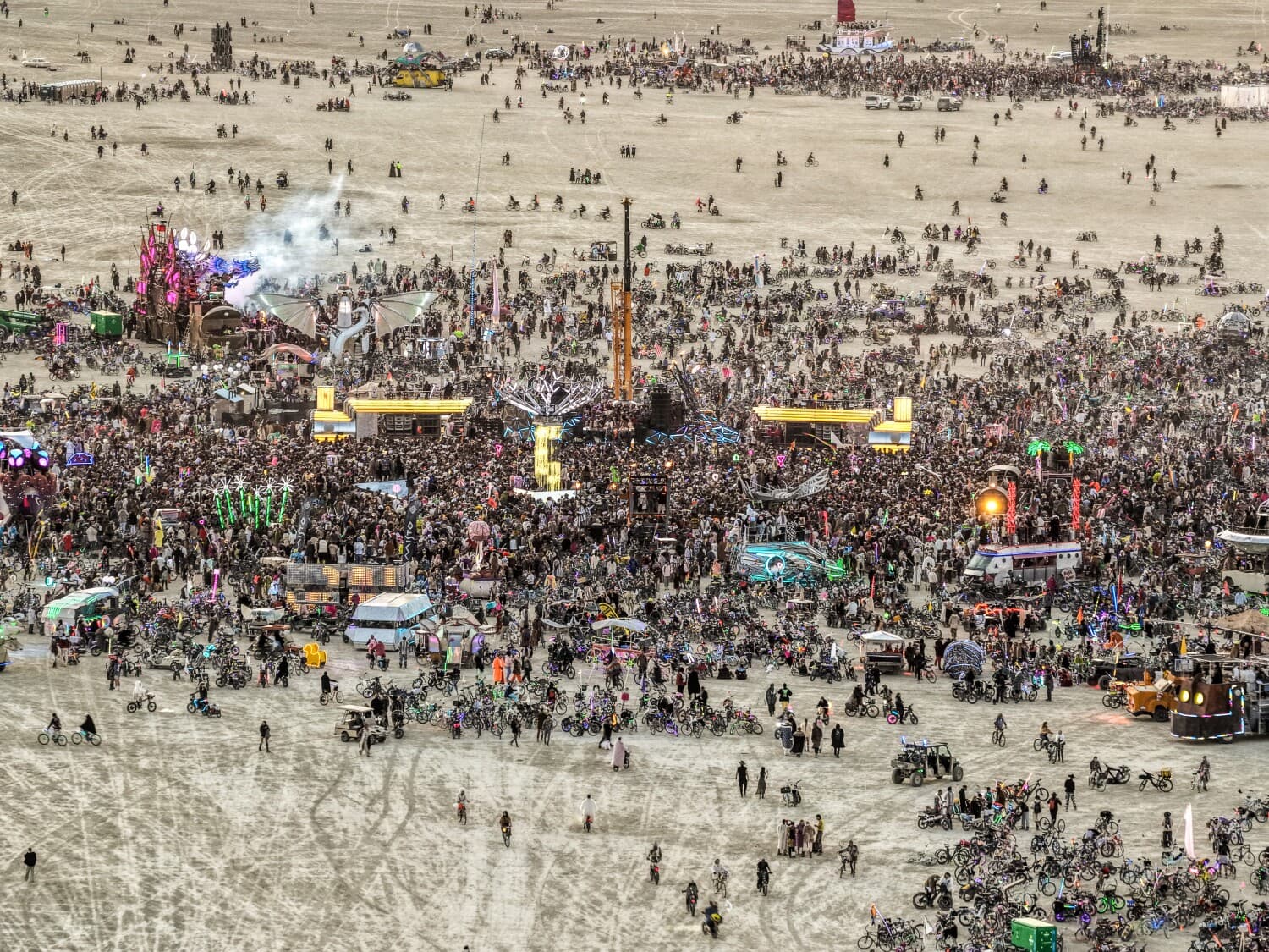 Aerial view of BiPolar Express, Singularity Tree and MAXA linked amid a vast Playa crowd