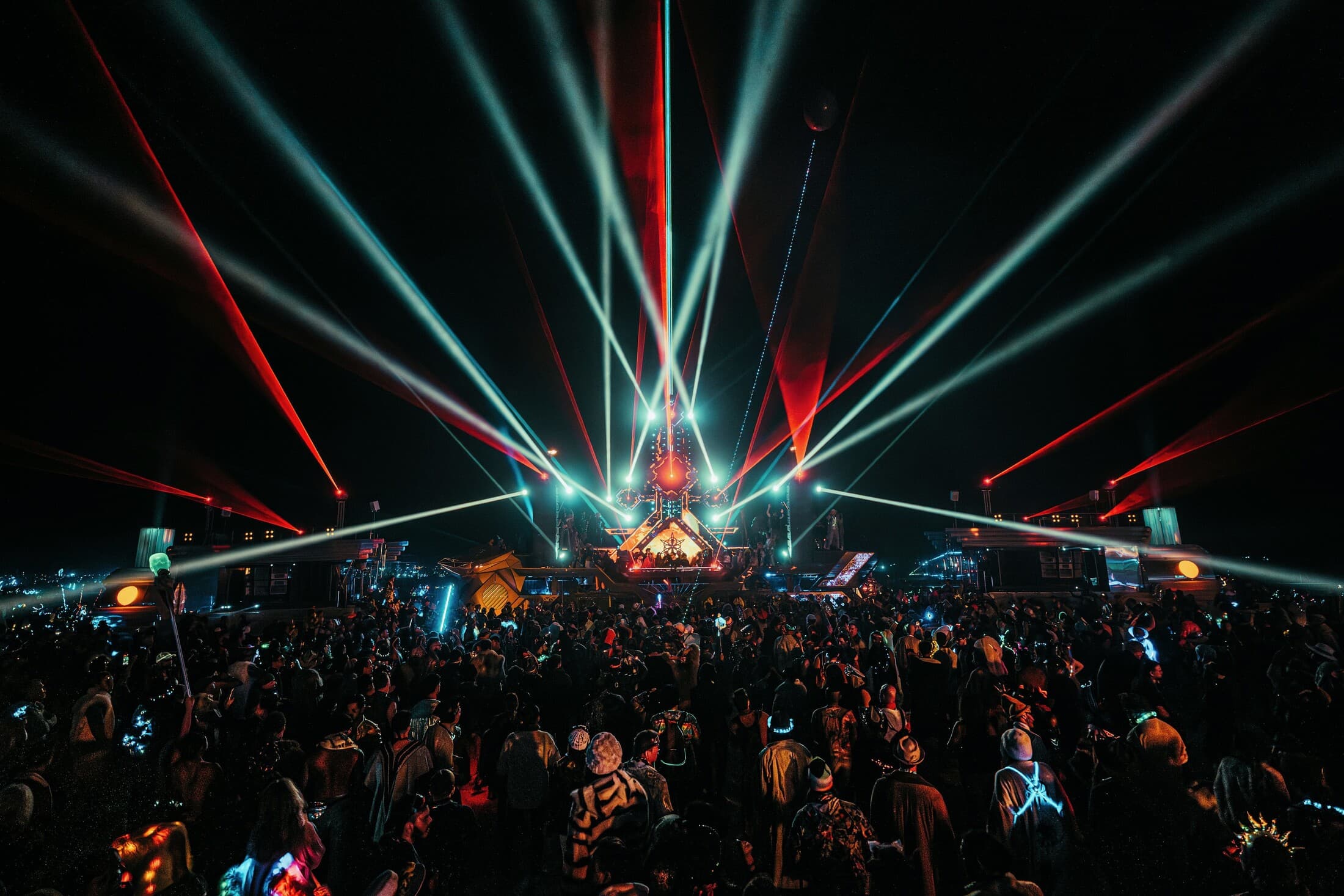 BiPolar Express and Mayan Warrior joined beneath a red and white laser show