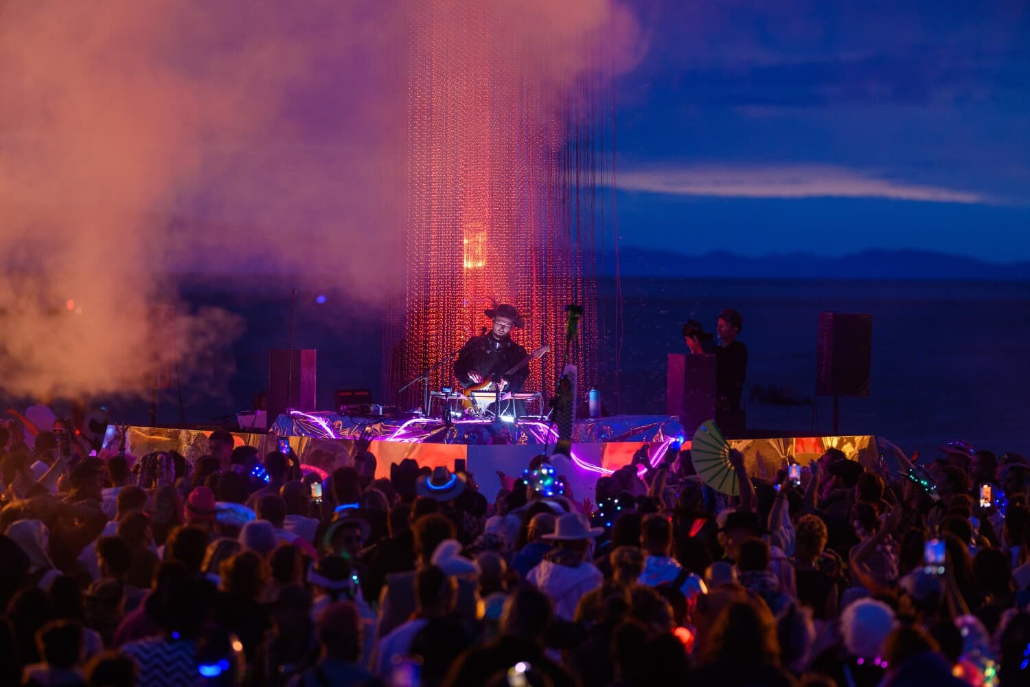 Monolink performing before the illuminated strands of the Singularity Tree at dusk