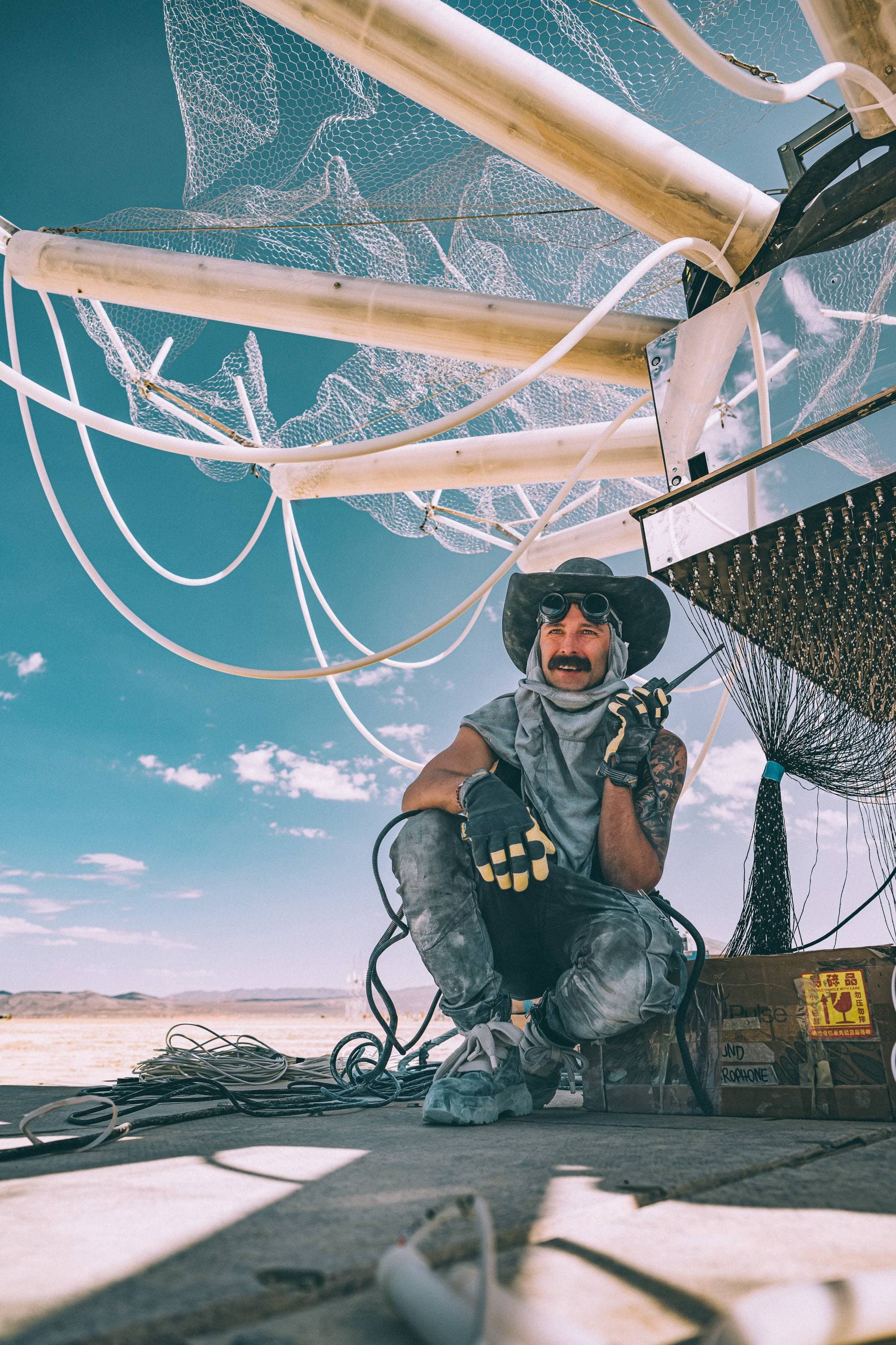 A Clear Visionary crew member with a radio beneath the unfinished Singularity Tree structure